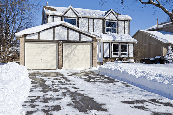 House with Snow in Driveway